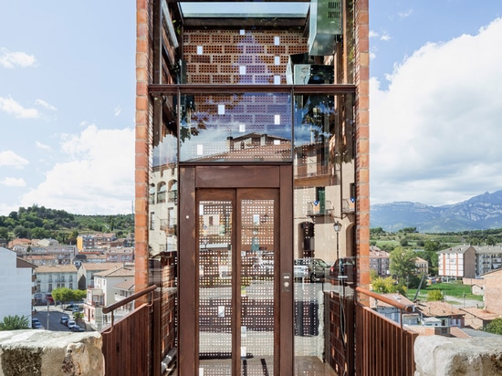 Perforated brick elevator by Carles Enrich connects medieval Spanish town to riverside