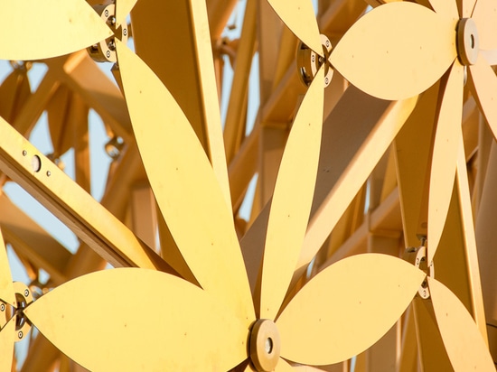 the freeform roof is composed of a load-bearing 3D frame with over 4,000 golden aluminum leaves