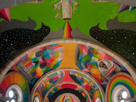 okuda san miguel paints colorful mural within converted church's indoor skate park