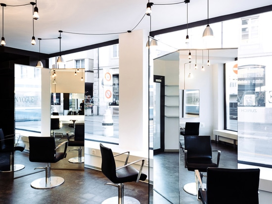 Sculptural mirrors frame spaces in Zurich barbershop by Wülser Bechtel Architekten