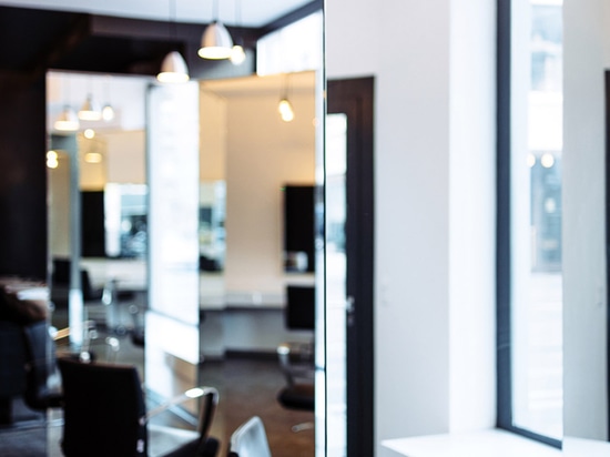 Sculptural mirrors frame spaces in Zurich barbershop by Wülser Bechtel Architekten