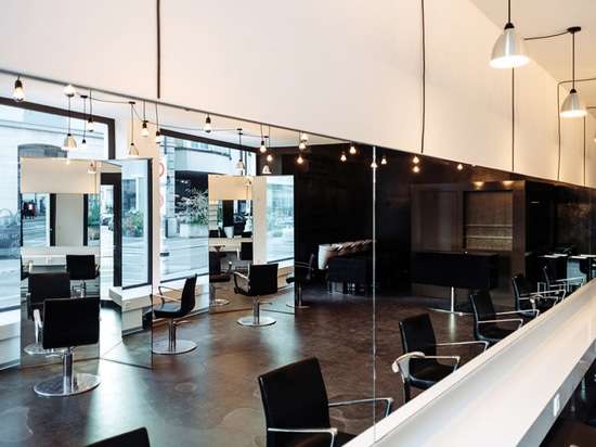 Sculptural mirrors frame spaces in Zurich barbershop by Wülser Bechtel Architekten