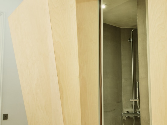 Atelier 37.2 installs sculptural wooden bathroom inside Haussmann-era apartment