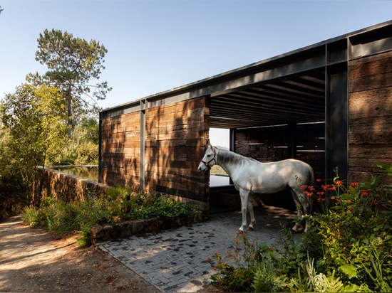 Stable built from railway sleepers tops El Mirador House in Mexico by CC Arquitectos