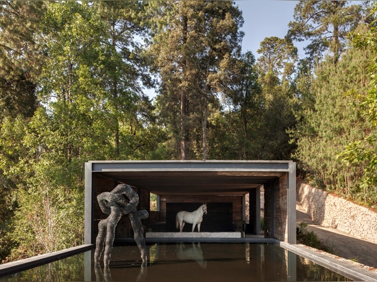 Stable built from railway sleepers tops El Mirador House in Mexico by CC Arquitectos