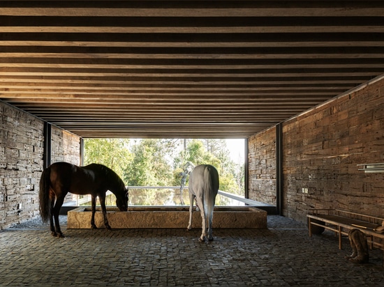 Stable built from railway sleepers tops El Mirador House in Mexico by CC Arquitectos