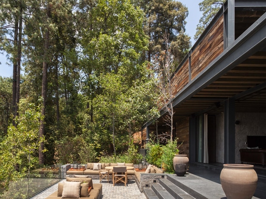 Stable built from railway sleepers tops El Mirador House in Mexico by CC Arquitectos