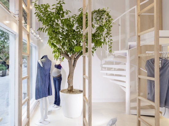 the store’s white steel spiral staircase is presented as a sculpture from the entrance