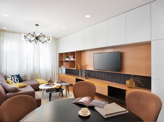 Sunny pops of yellow are found throughout this apartment interior