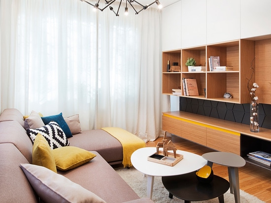 Sunny pops of yellow are found throughout this apartment interior