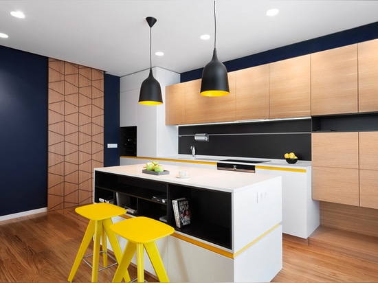 Sunny pops of yellow are found throughout this apartment interior