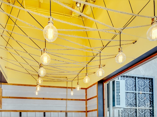 a rope installation fills the tall ceiling space