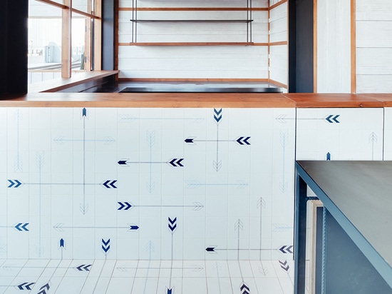 tiles with an arrowhead motif lines the counters and floor