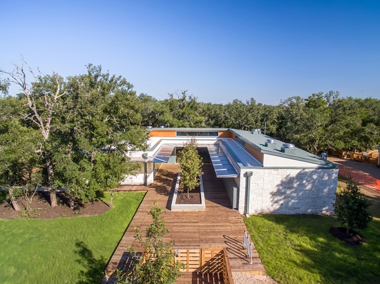 The polygal awning wraps the building to protect the doors and windows, as well as pedestrians below.  During a central Texas thunderstorm, raindrops create the soothing background sound of a muffl...