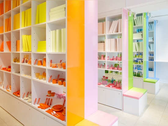 the space inside is partitioned by large shelves colored in orange, pink, green and blue