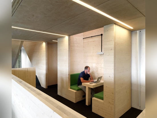 Multi-level wooden structure frames meeting areas in London office by Threefold Architects