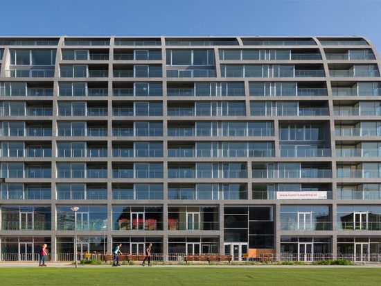 MVRDV's ambitious Markthal building opens in Rotterdam, housing a busy food market within its striking arch