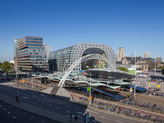 MVRDV's ambitious Markthal building opens in Rotterdam, housing a busy food market within its striking arch