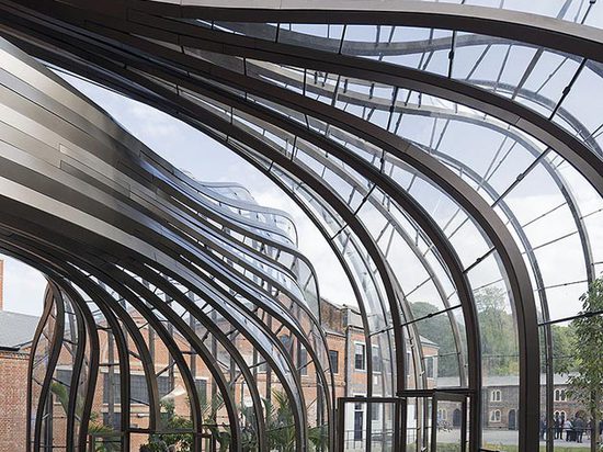 The complex includes two glass houses that cleverly make use of the excess heat produced during the distillation process. Photography: Iwan Baan