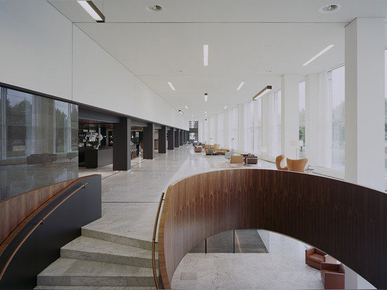 Powerhouse Company remodels office foyer in marble and dark wood to resemble a hotel lobby