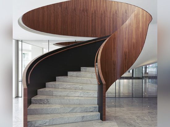 Powerhouse Company remodels office foyer in marble and dark wood to resemble a hotel lobby