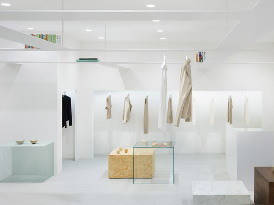 Nendo's grid of suspended bookshelves hangs above shoppers in Beige fashion boutique