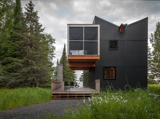 Timber gallery sits above the veranda of Salmela Architect's lakeside retreat