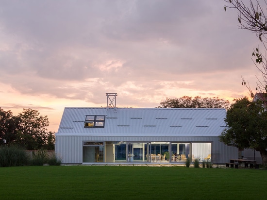 the building is a contemporary take on the local farmhouse, shed structures