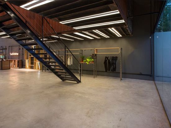 Shipping containers are suspended above shoppers inside Le Utthe boutique