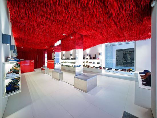 30,000 red shoelaces hang from the ceiling of Melbourne's Camper store