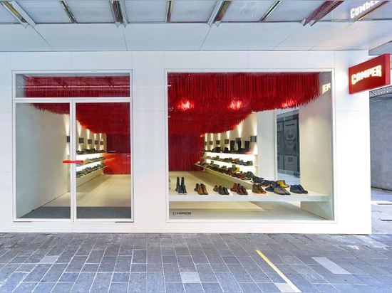 30,000 red shoelaces hang from the ceiling of Melbourne's Camper store