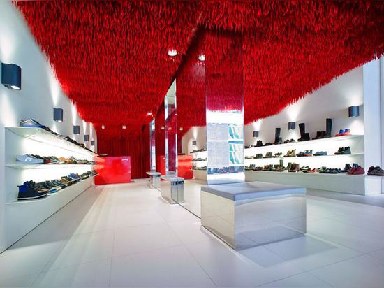 30,000 red shoelaces hang from the ceiling of Melbourne's Camper store