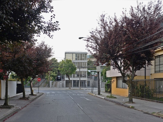 the structure has been built on a hillside next to a public park that runs parallel with the street