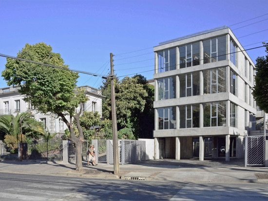 the narrow concrete office building is located on the outskirts of concepción’s city center