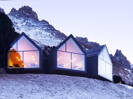 Stunning wooden Oberholz Mountain Hut branches out of the mountainside like a fallen tree