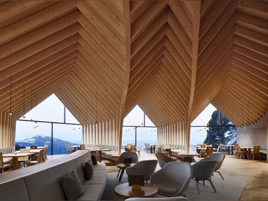 Stunning wooden Oberholz Mountain Hut branches out of the mountainside like a fallen tree