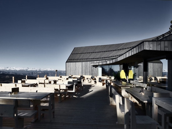 Stunning wooden Oberholz Mountain Hut branches out of the mountainside like a fallen tree