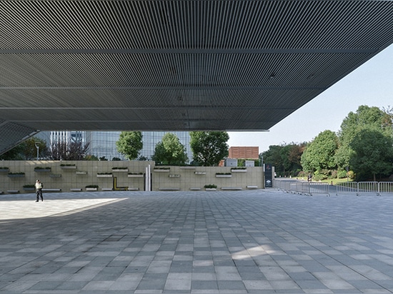 OMA completes elevated exhibition venue above a public plaza in shanghai