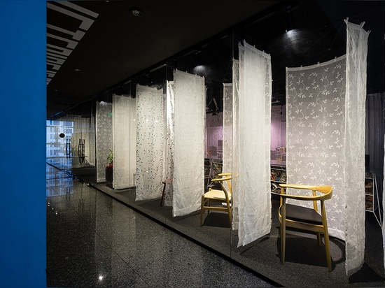 atelier tho.A drapes gamma’s office space with translucent ‘fabric walls’