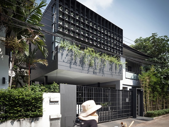 anonym studio turns old living estate in bangkok into a vibrant flower cage house