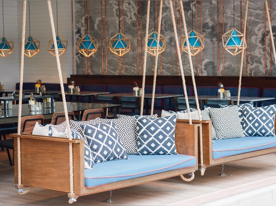 A Pair Of Swinging Sofas Greet You At This Restaurant