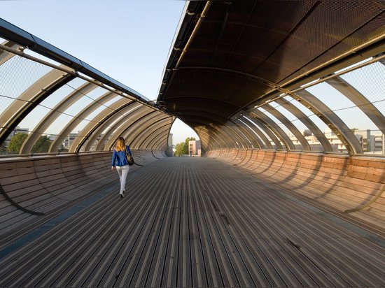 Gateway Villetaneuse footbridge unfurls like a leaf over train tracks outside Paris