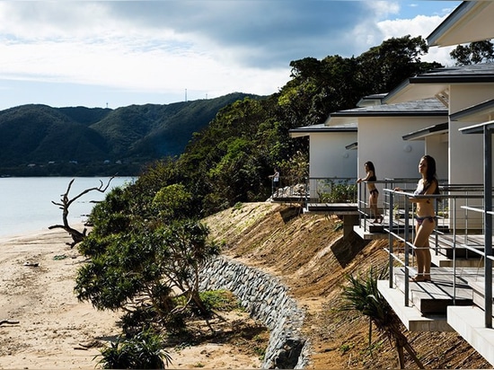 'nest at amami' is a remote japanese beach village built between the sky and the sea