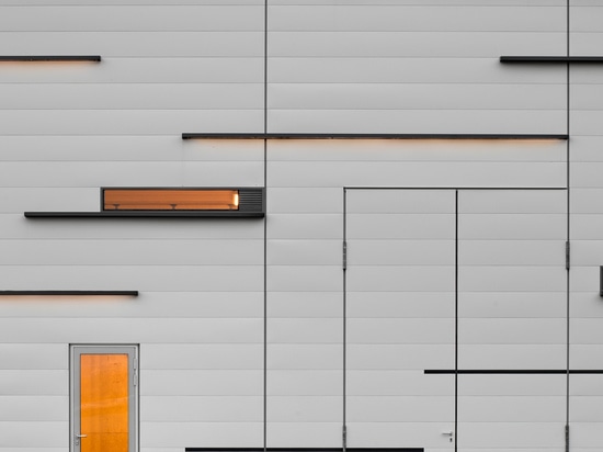 Subtle composition: dark grey coated horizontal elements, joints, narrow window openings