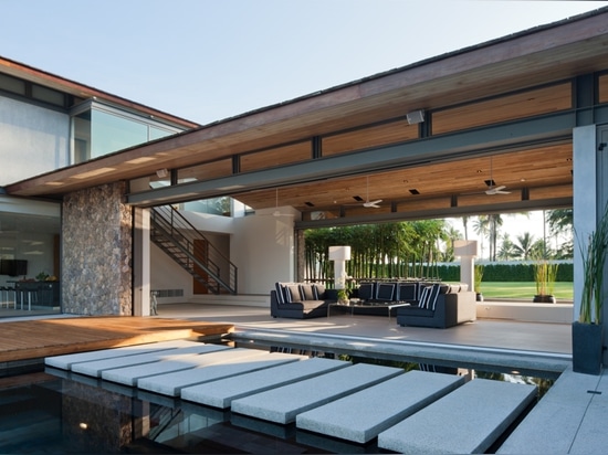 the main living area has doors that pocket into the adjacent walls to create a feeling of openness