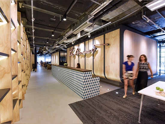 suspended above the reception desk is a custom made bulb installation of leo burnett’s company logo