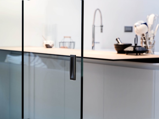 The all-glass sliding door dynamically separates the kitchen and living area