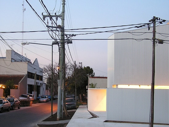 the structure uses sheet metal to stand out from surrounding buildings