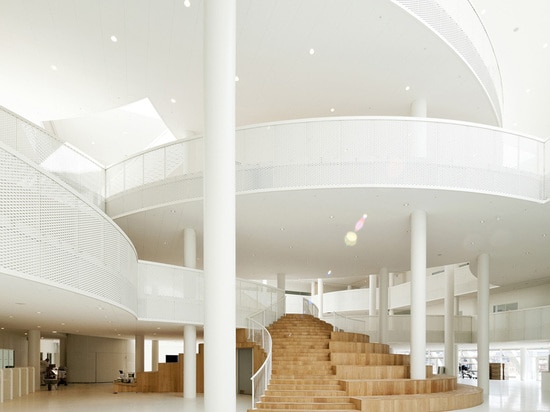 rounded shapes form a series of balconies and platforms with shifting overlaps across the atrium