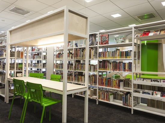 seating and tables are integrated into the book shelves